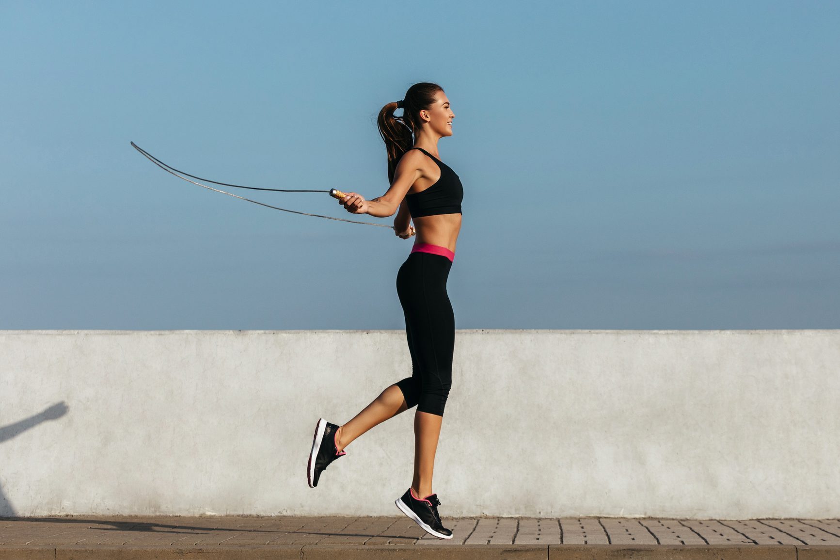 Young woman training with a jumping rope