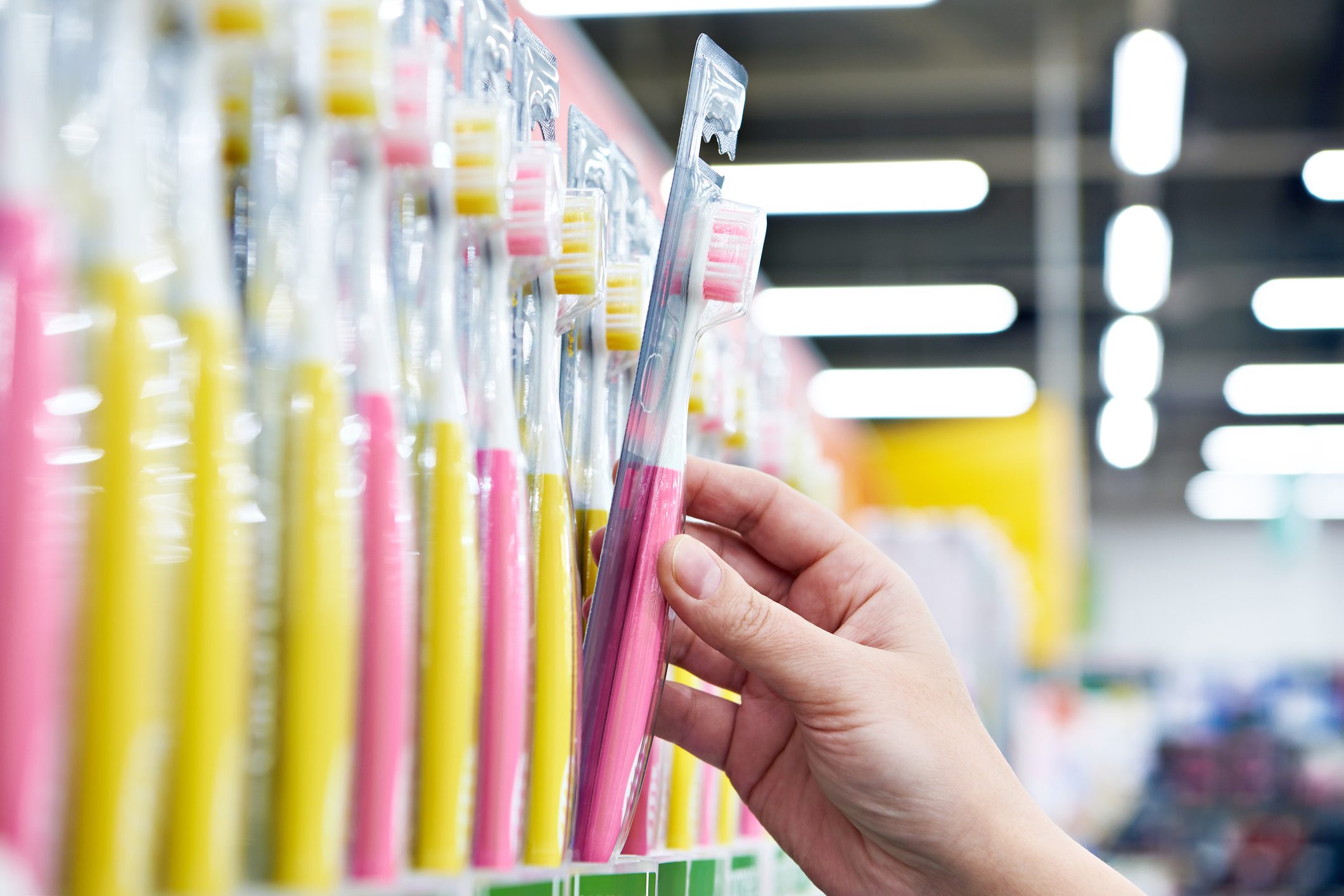 Toothbrush in package in hand in store