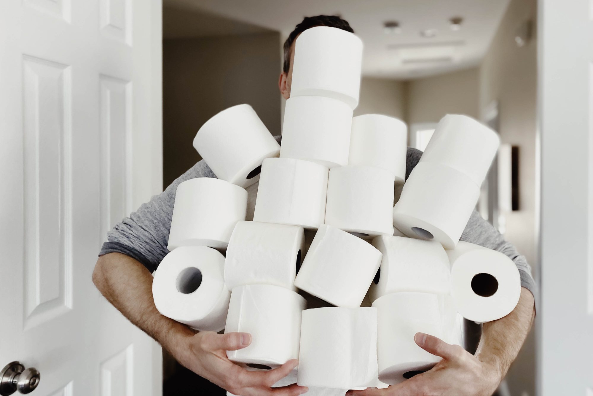 Man Carries Heap of Toilet Paper