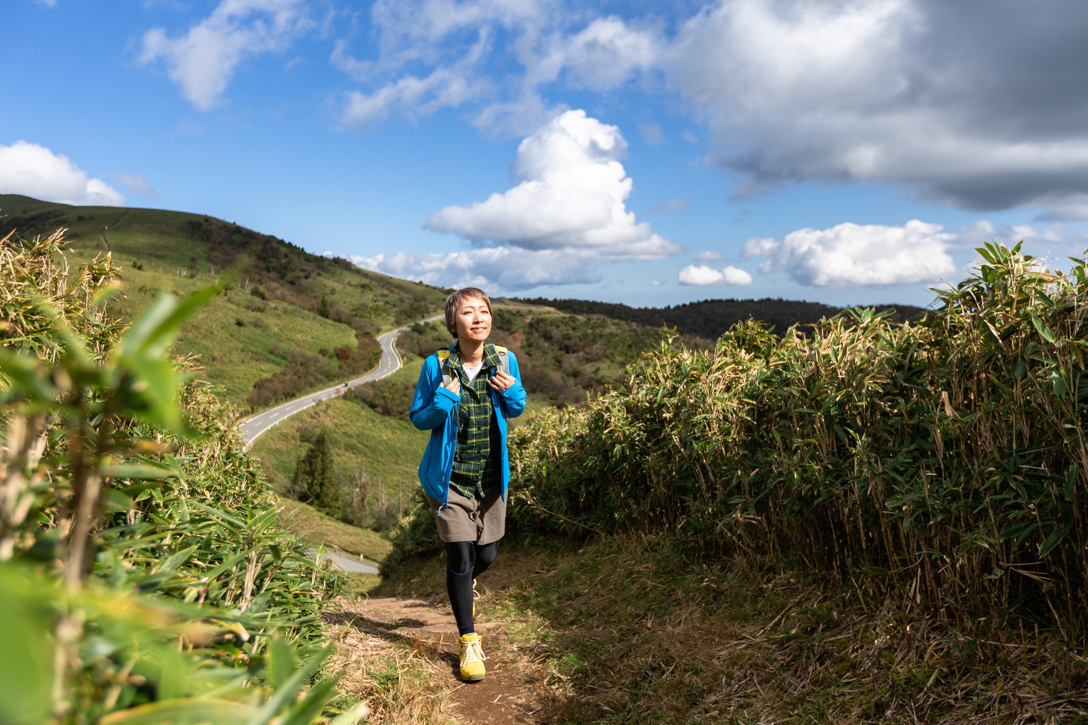 A woman hiking in the mountains in the fall