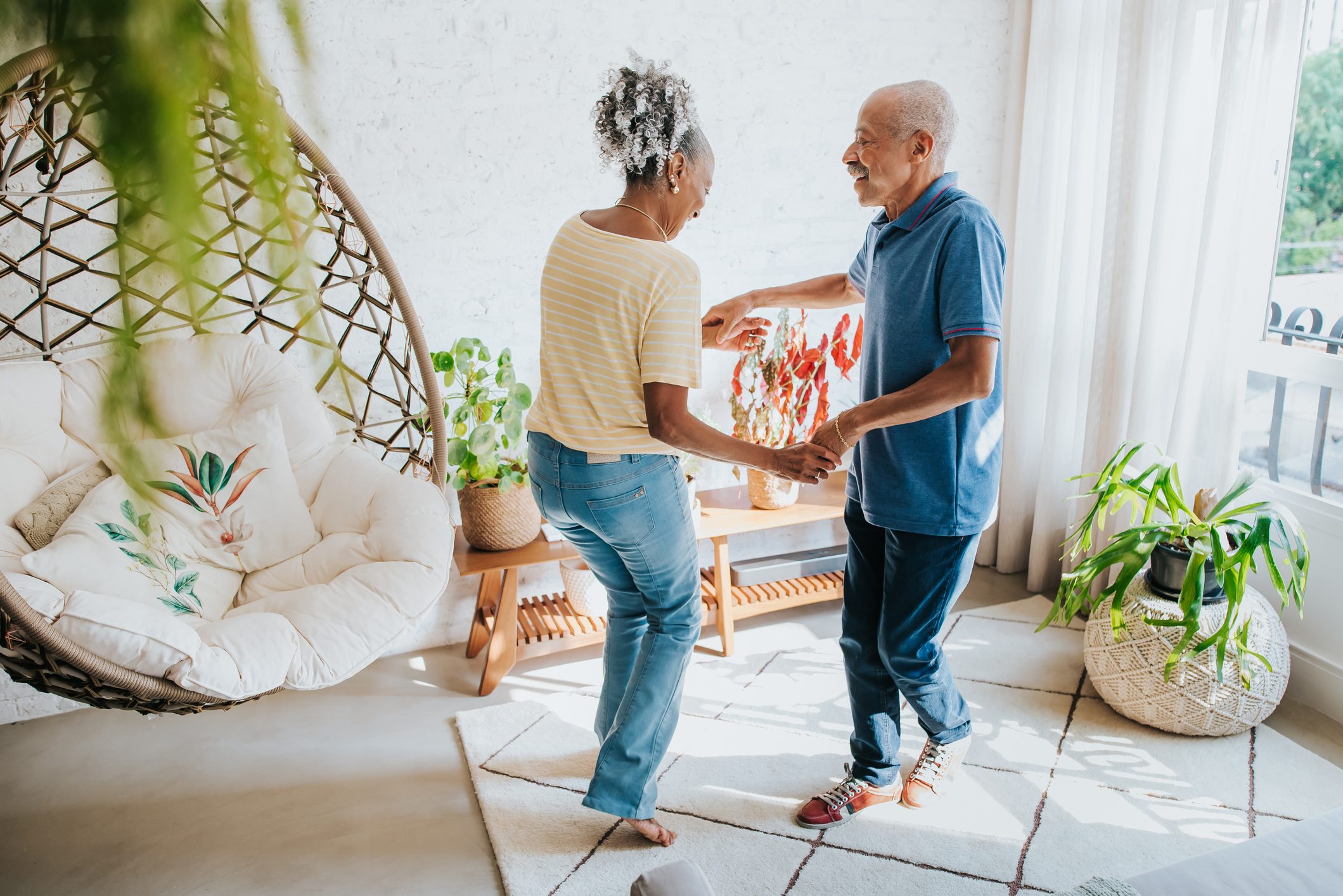 Carefree senior couple dancing in the living room