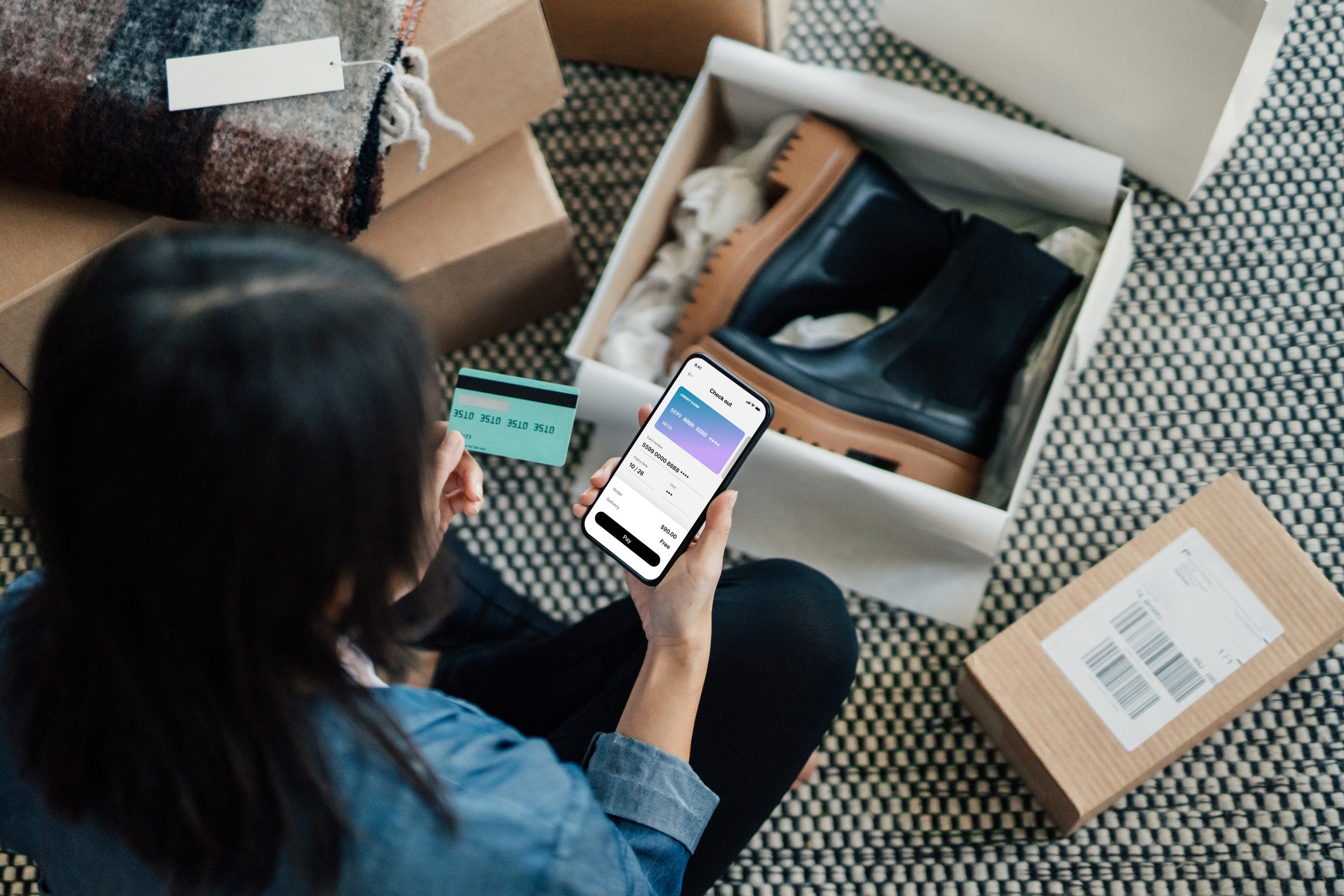 Overhead View Of Young Woman Doing Online Shopping With Smart Phone