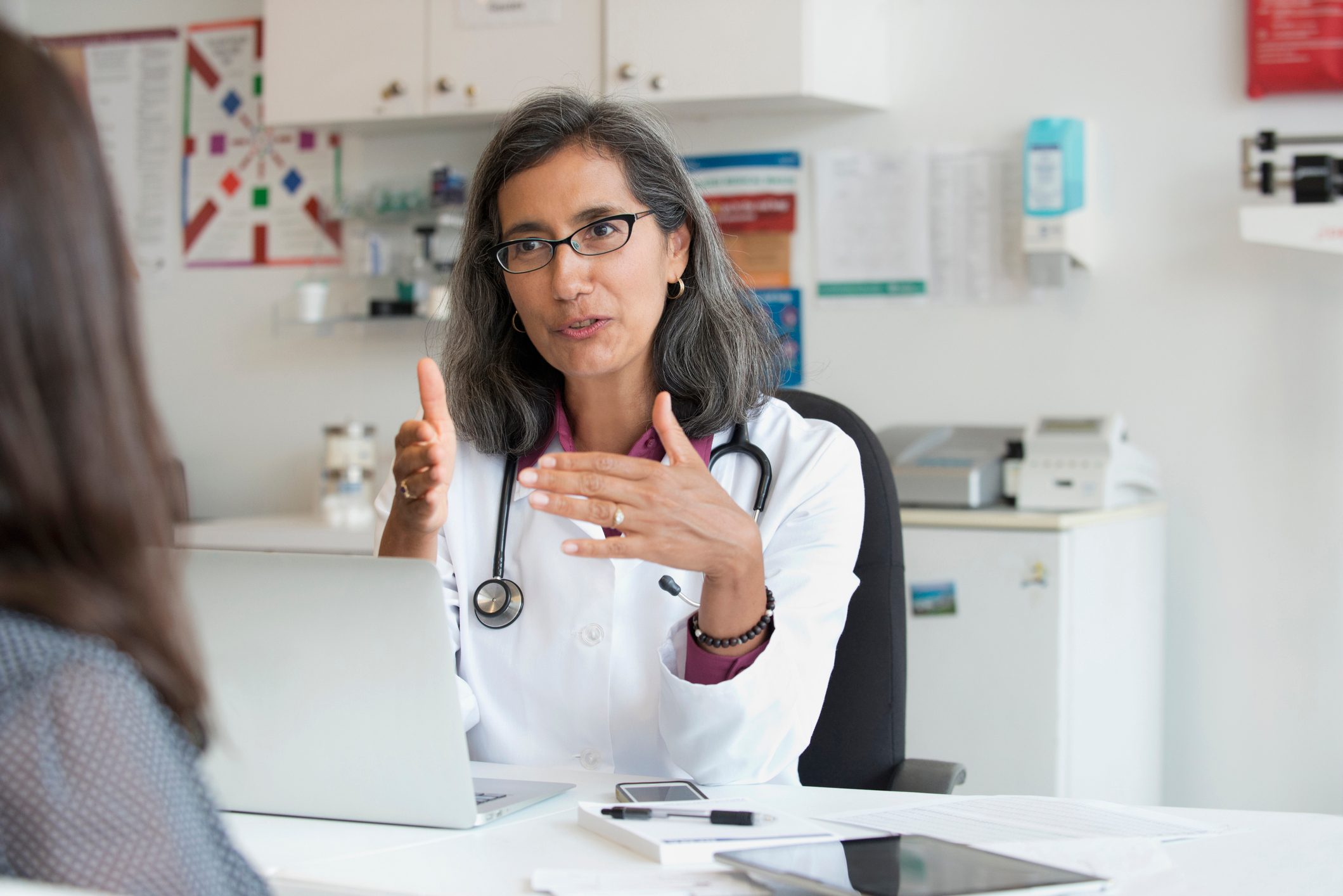 Mixed Race doctor talking to patient