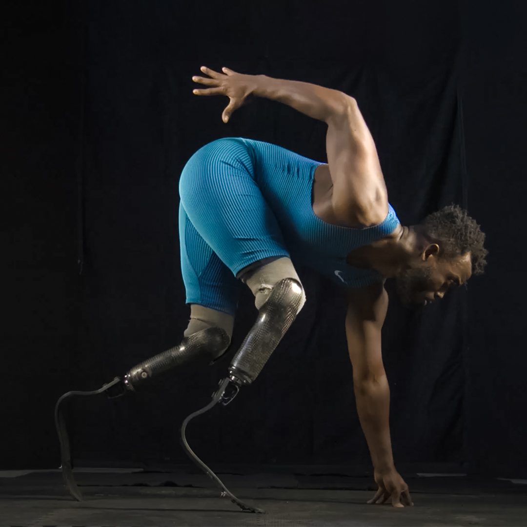 portrait of Blake Leeper about to run in a studio with a black background