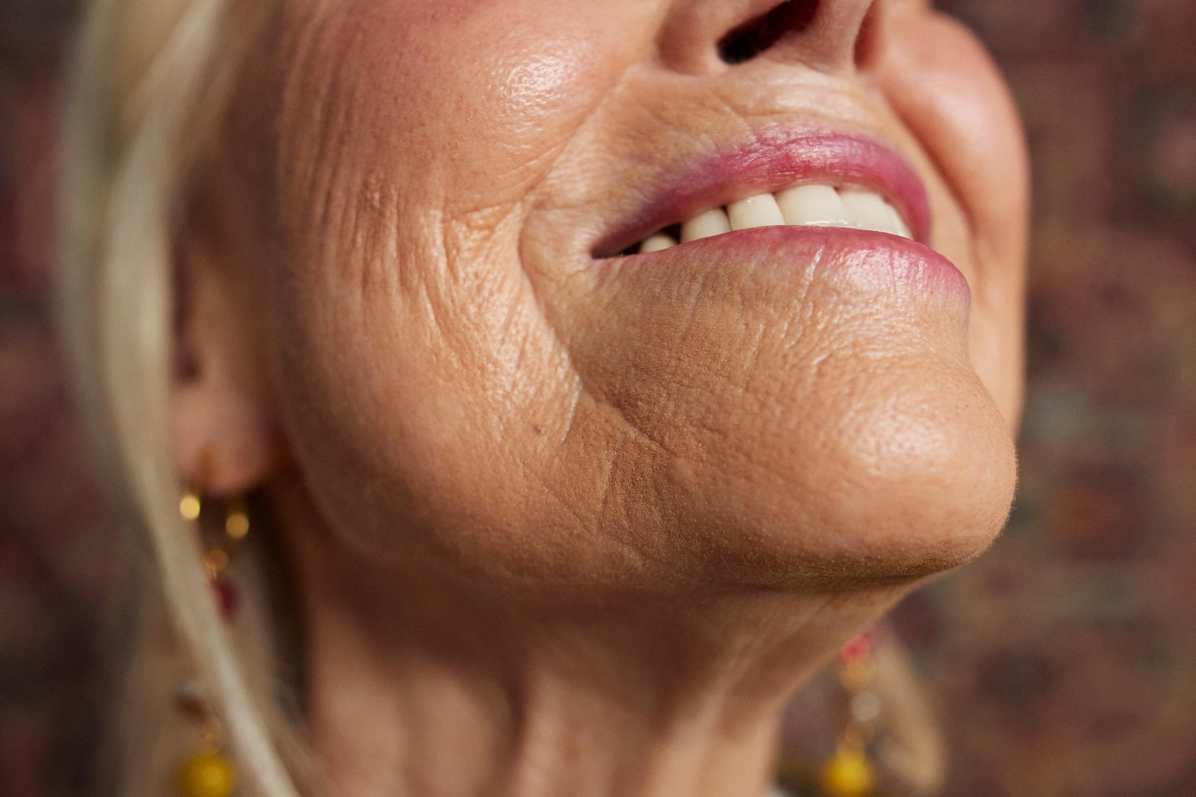 close up of woman smiling with facial wrinkles