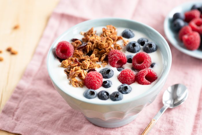 Yogurt with granola and berries in bowl