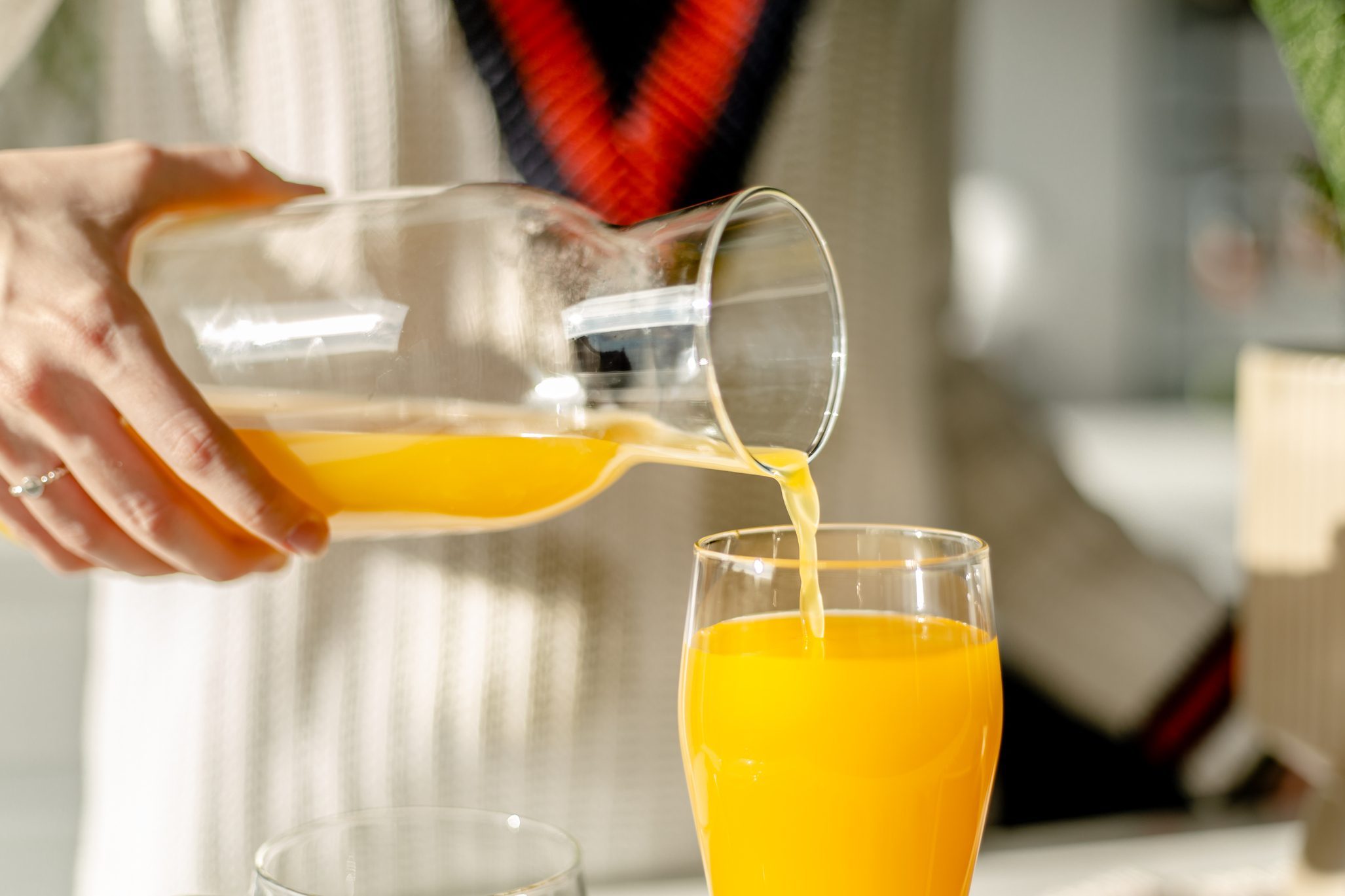 Drinking juice in the kitchen close up