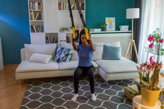 Home Workout With Suspension Straps doing assisted squats