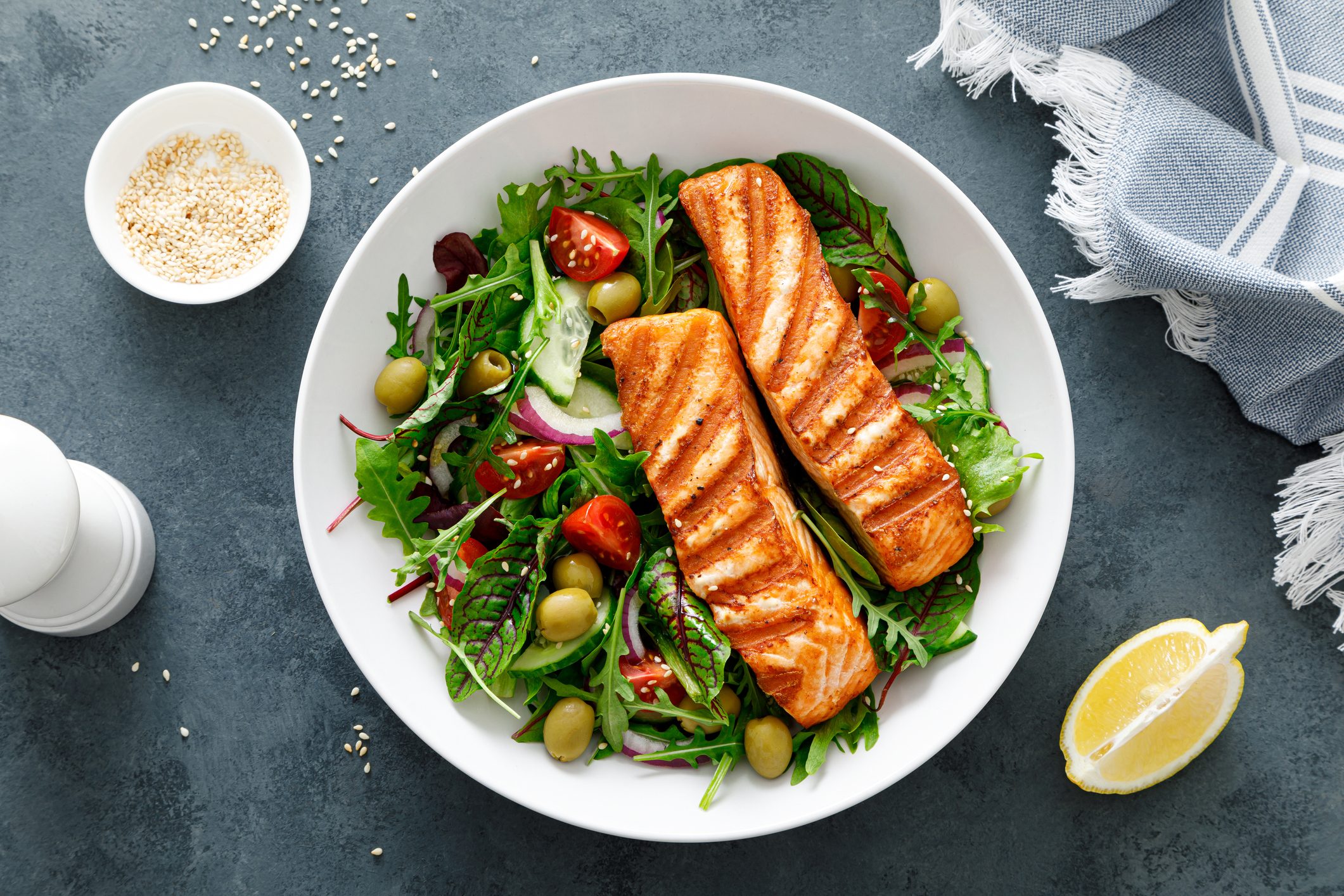 Grilled salmon fillet and fresh vegetable salad. Mediterranean diet.