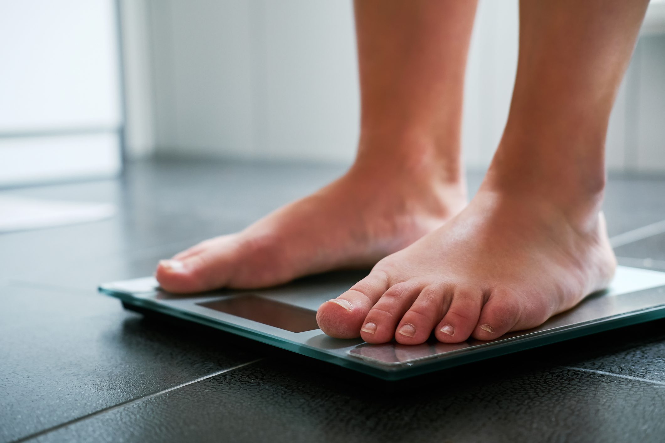 Female bare feet on the digital scale