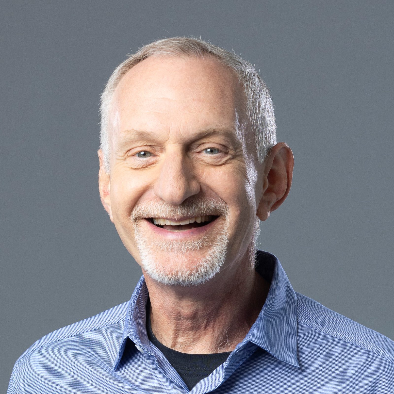 portrait of Robert Waldinger on a grey studio background