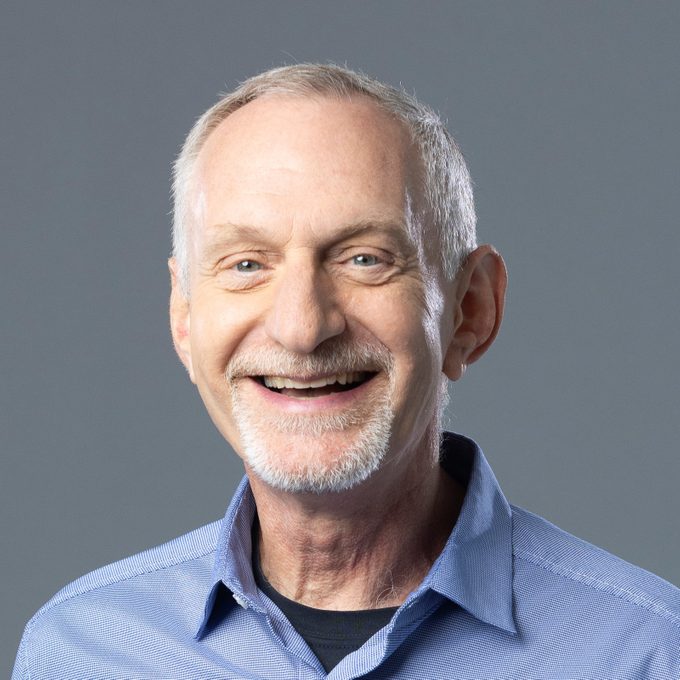 portrait of Robert Waldinger on a grey studio background