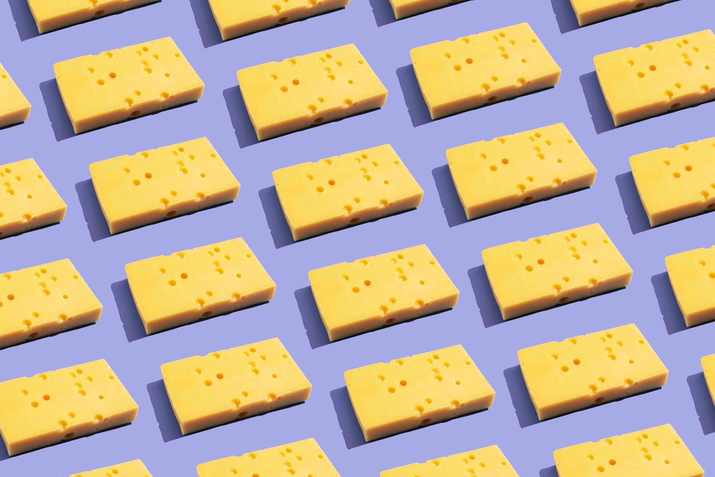 Cheese on the purple background arranged in a grid to fill the frame