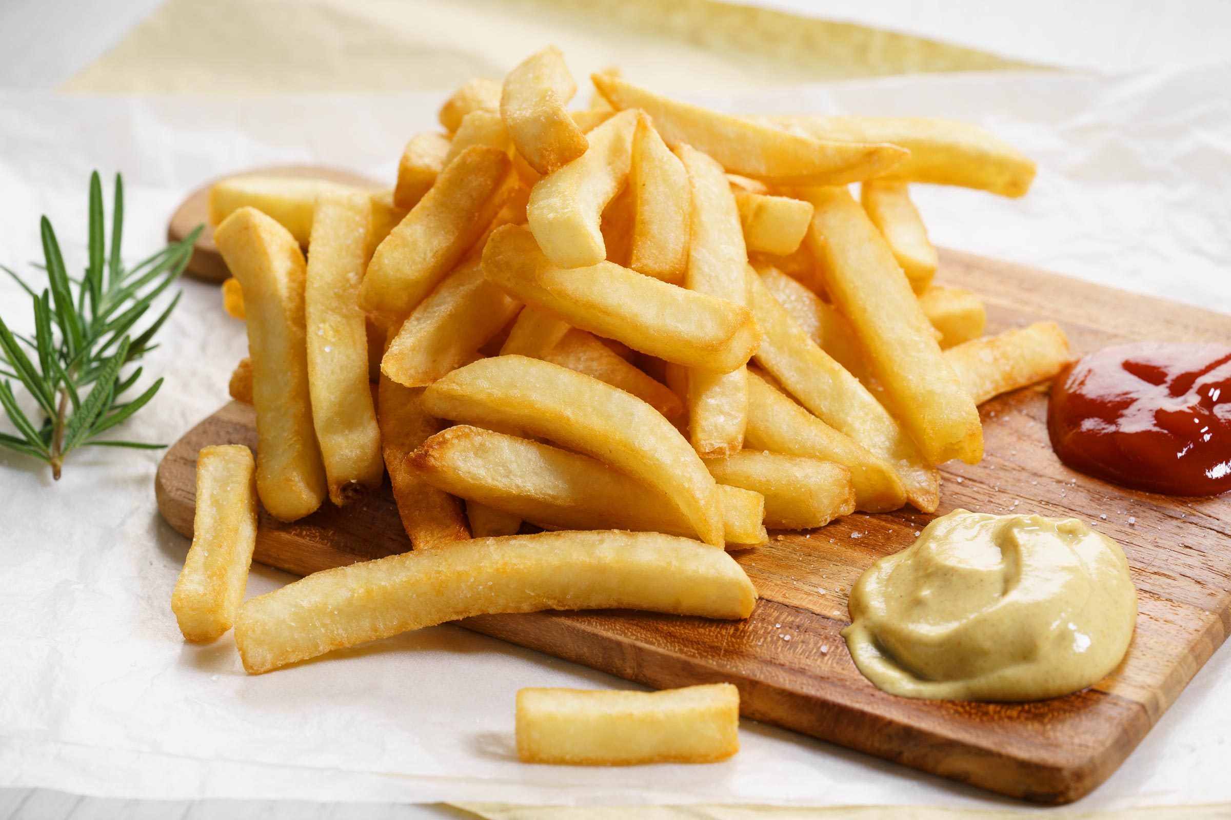 French fries with a side of spicy mustard and ketchup for dipping