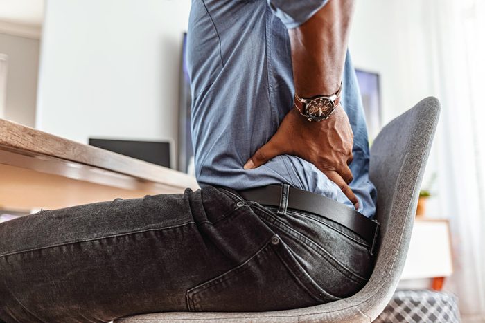 man Feeling the strain of a long day at his desk