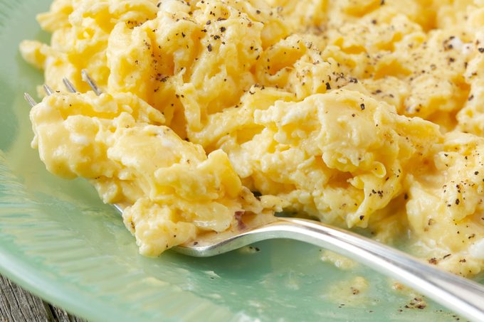 scrambled eggs on a green plate