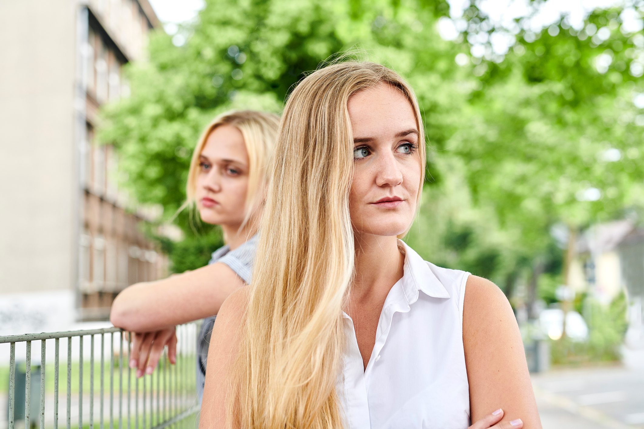 Two discontented young women outdoors