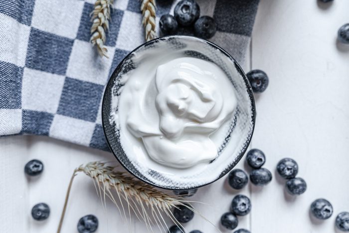 yogurt in bowl on wooden table. healthy eating