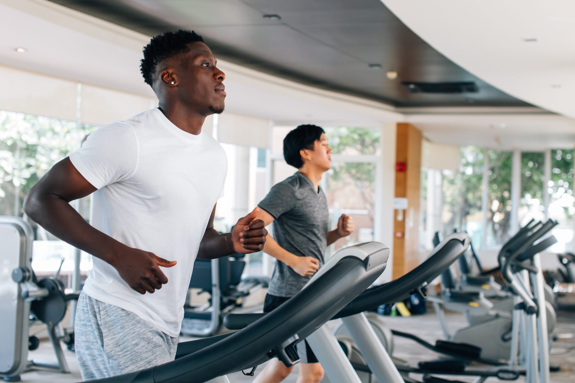 Multiethnic males running on treadmills