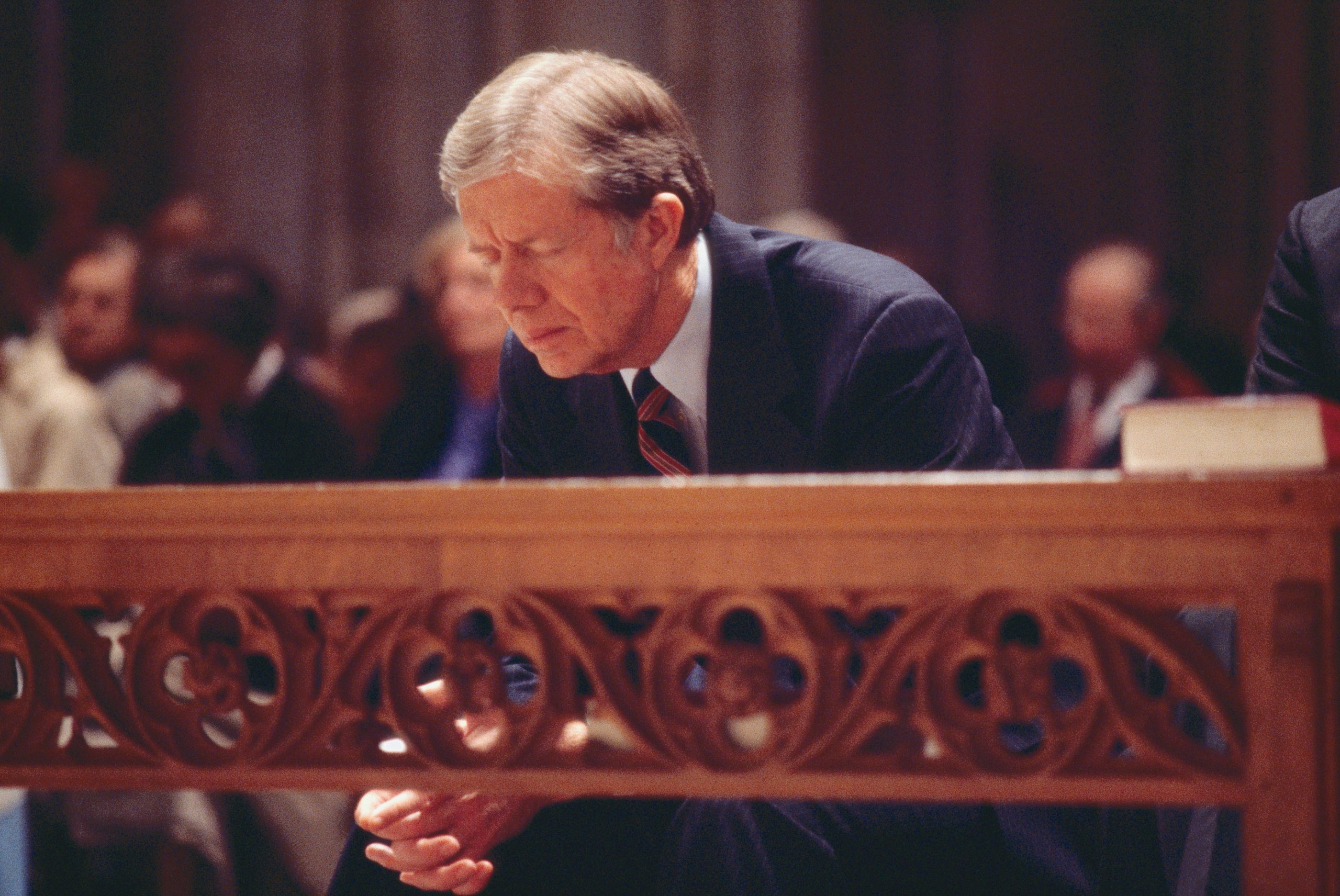 US President Jimmy Carter (left) bows during an Interfaith Prayer Service (held in honor of the hostages being held in Iran) at the Washington National Cathedral, Washington DC, November 15, 1979.