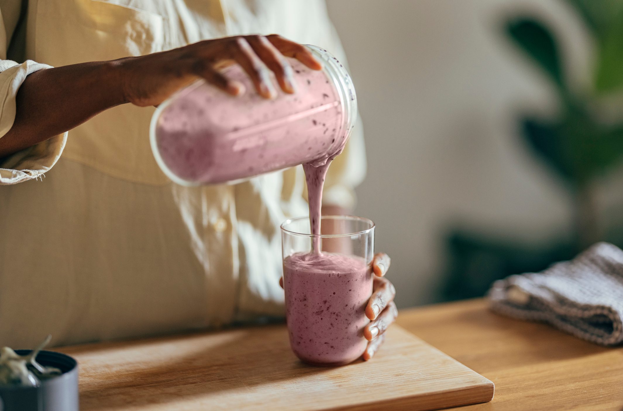 Anonymous Afro-American Woman Pouring a Smoothie Into a Glass