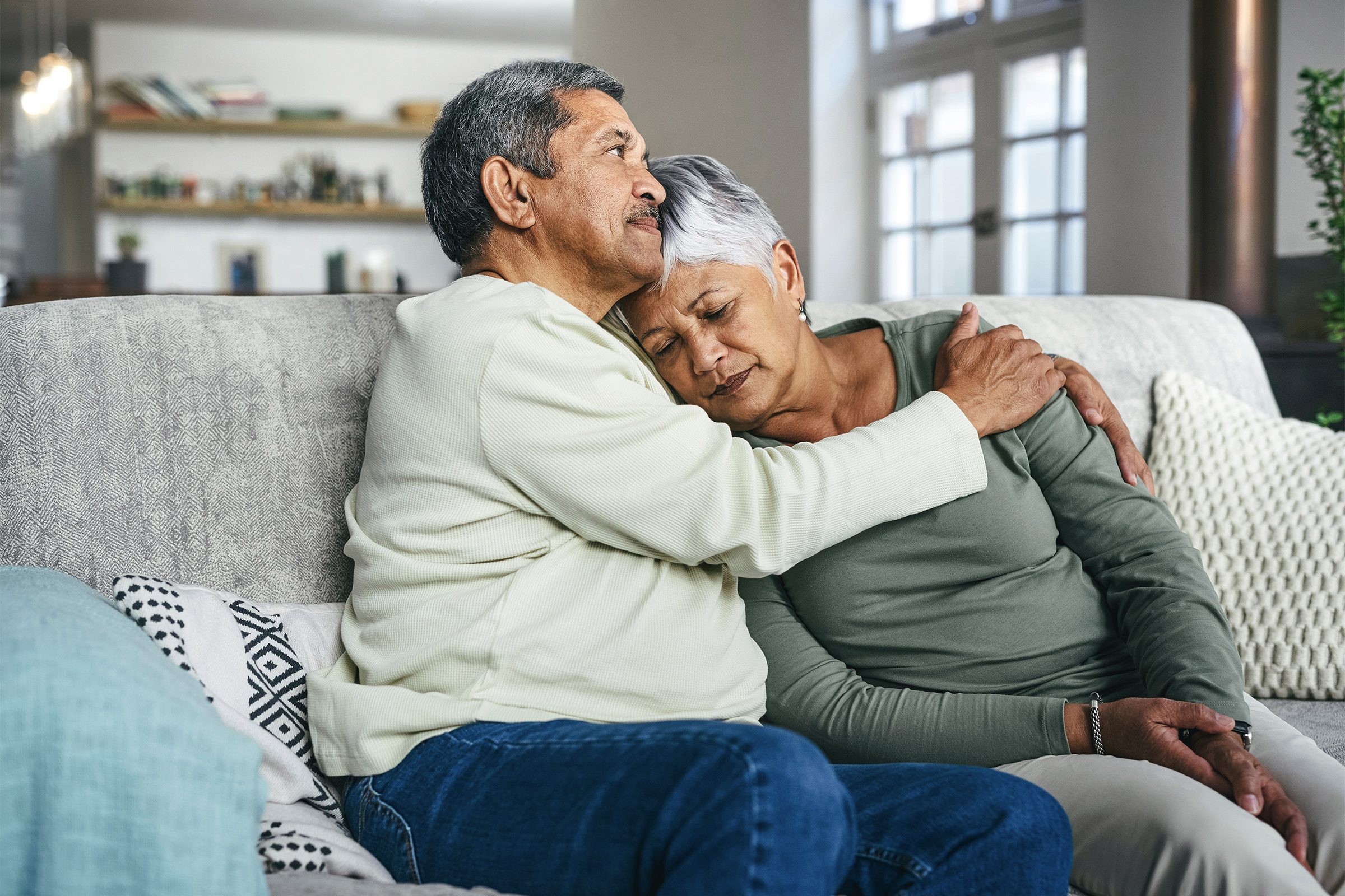 senior man supporting his wife during a difficult time at home