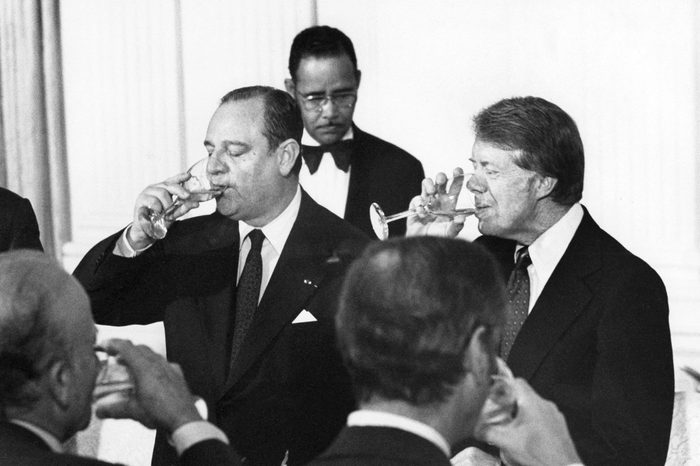 US President Jimmy Carter (R) and French Prime Minister Raymond Barre are pictured at the White House as they toasted each other at a working dinner for the visiting of PM Raymond Barre, 15 September 1977
