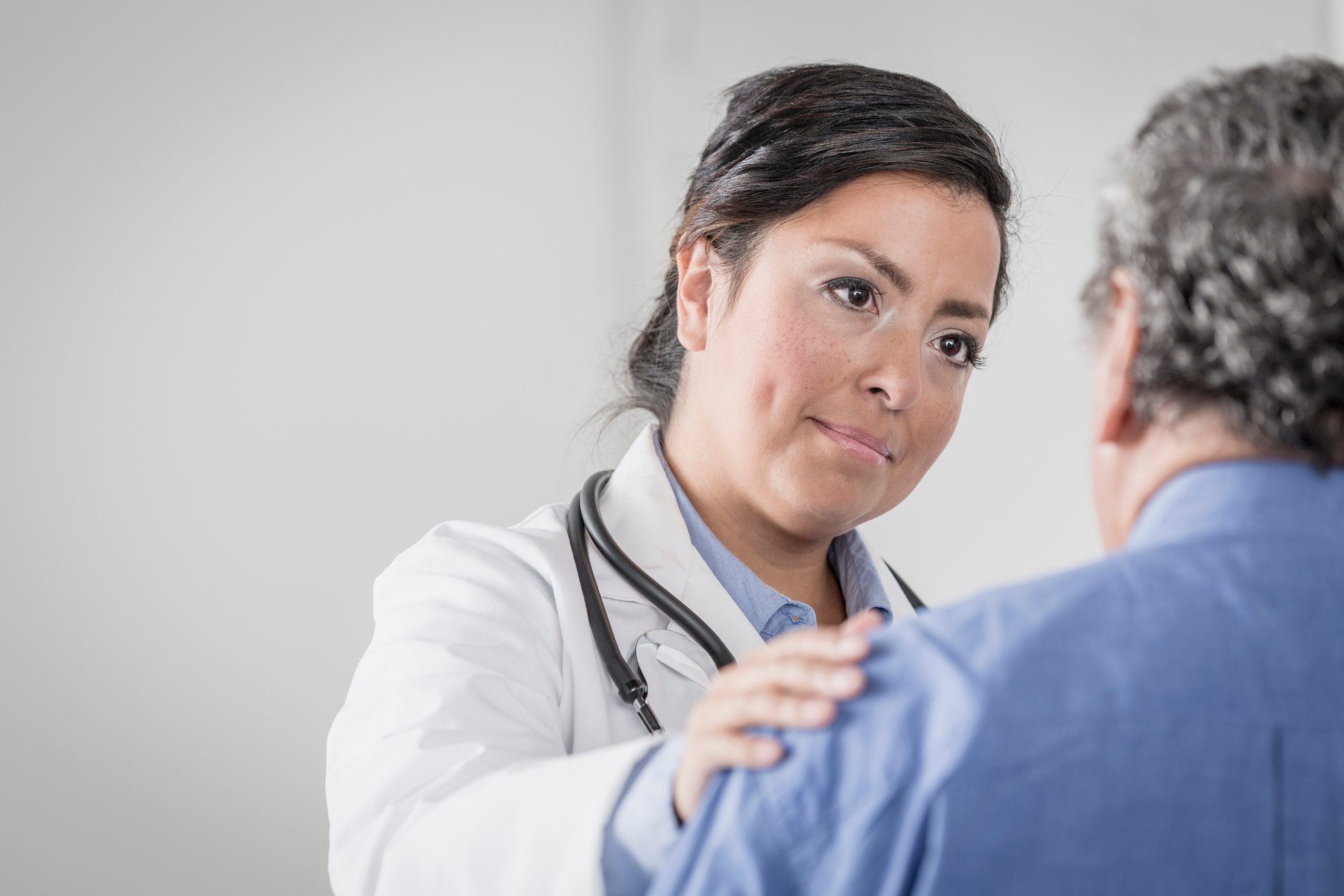 Doctor comforting senior patient