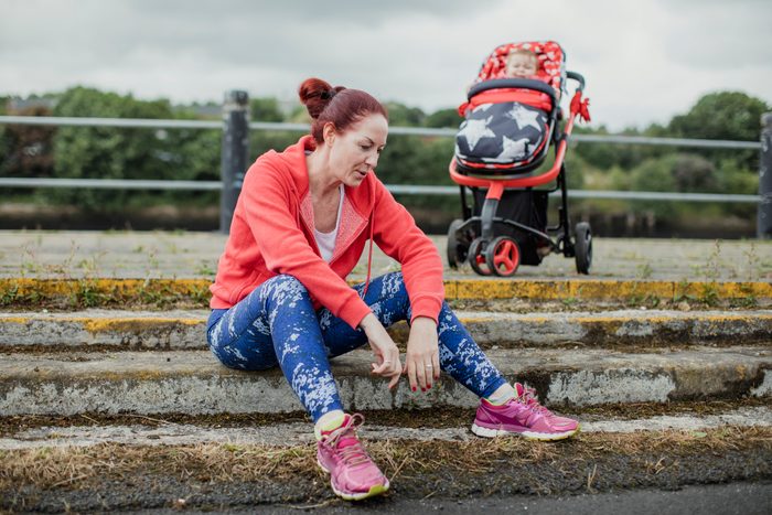 Multitasking Mother Taking A Break From Running