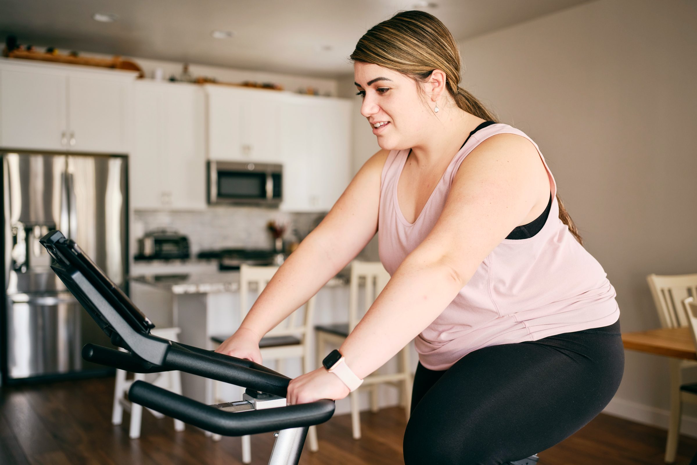 Woman Using Exercise Bike in a Home