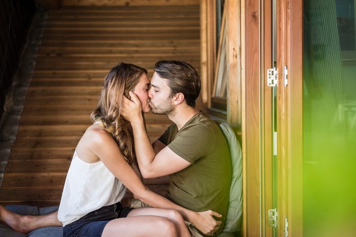 Affectionate couple kissing on balcony
