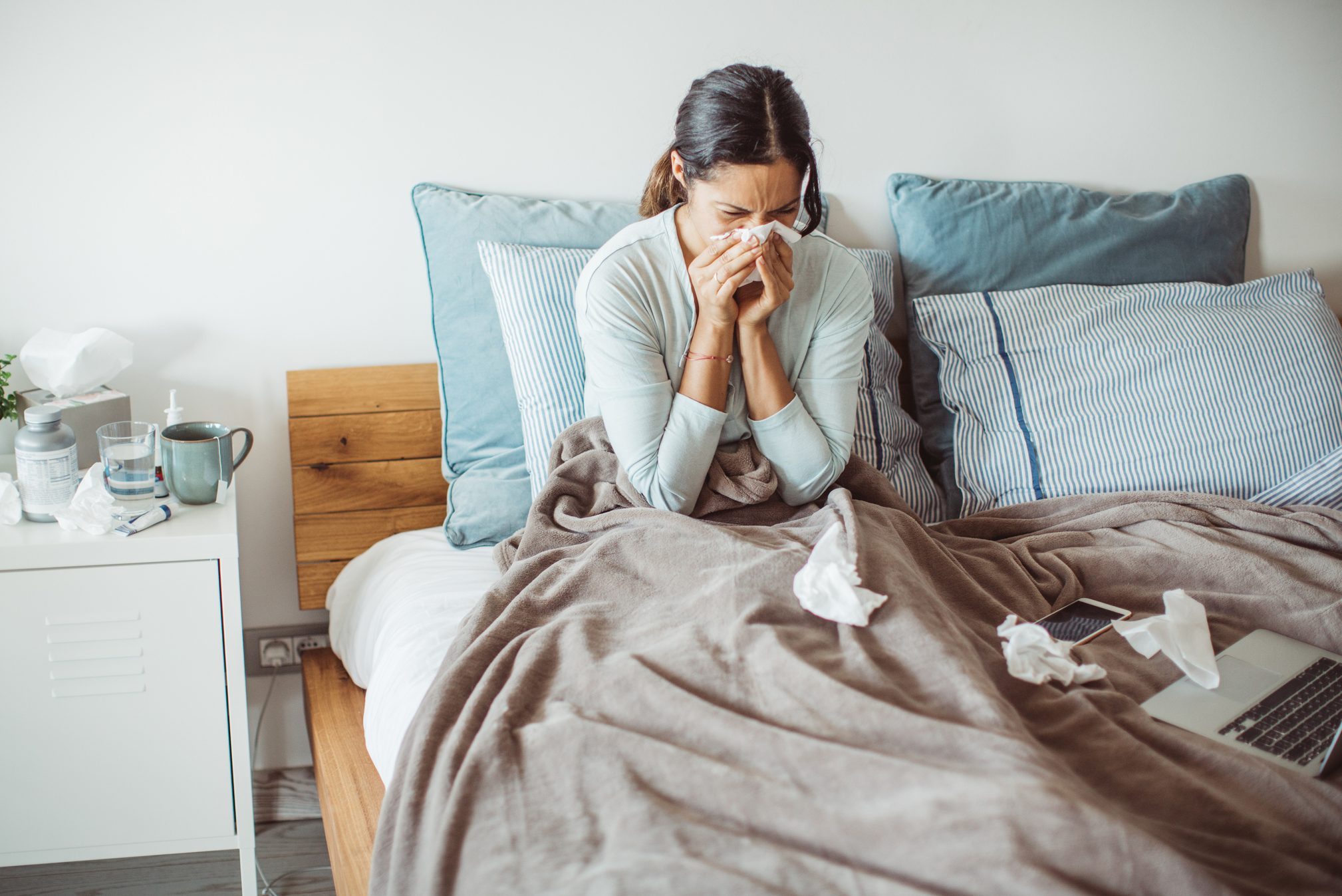 Woman with flu in bed, she use home medicine to handle sickness