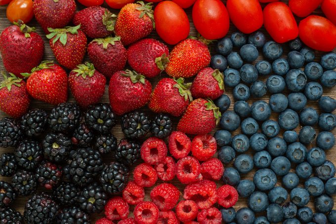 Overhead shot of mixed berries and grapefruit tomatoes