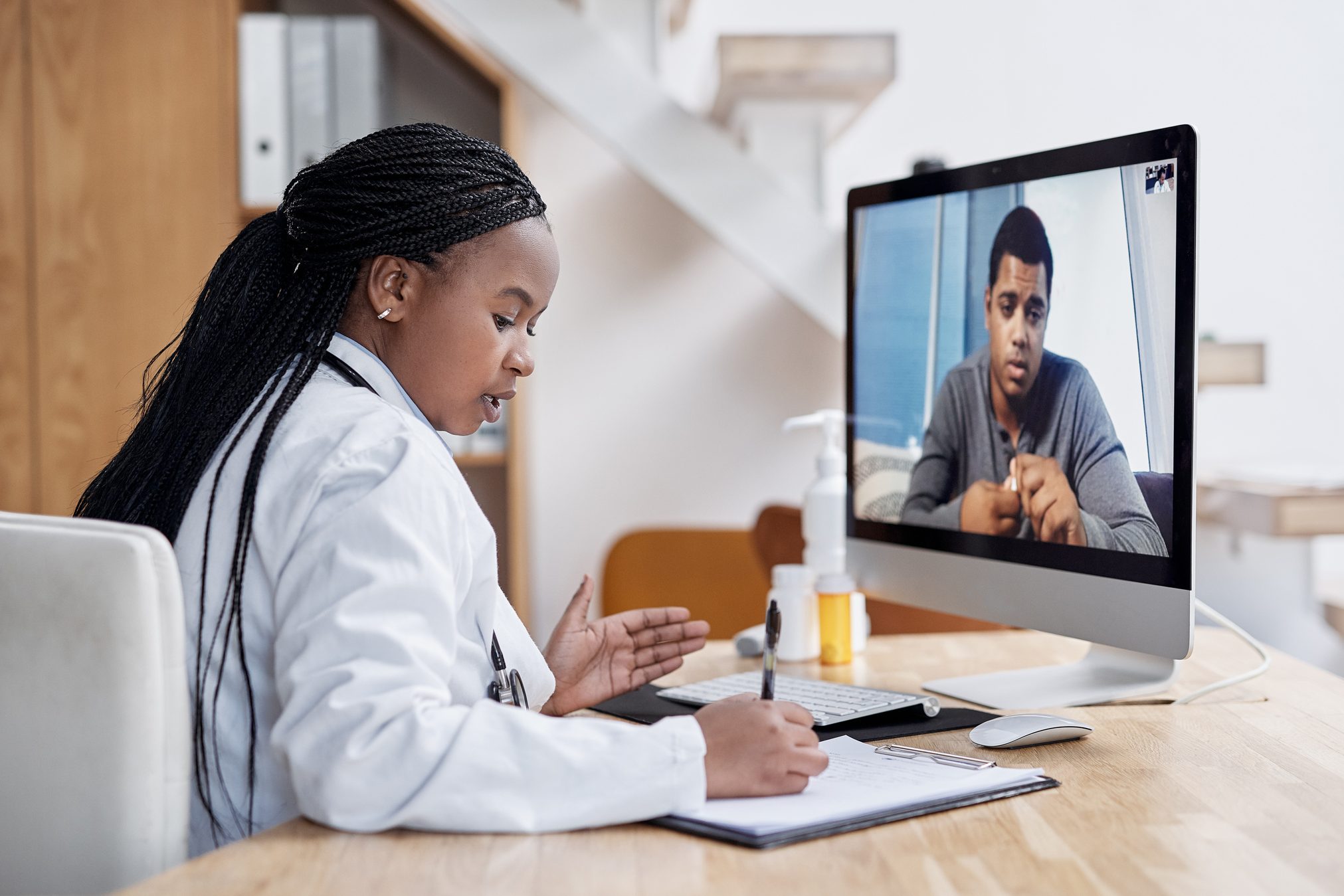 Taking notes during her virtual consult