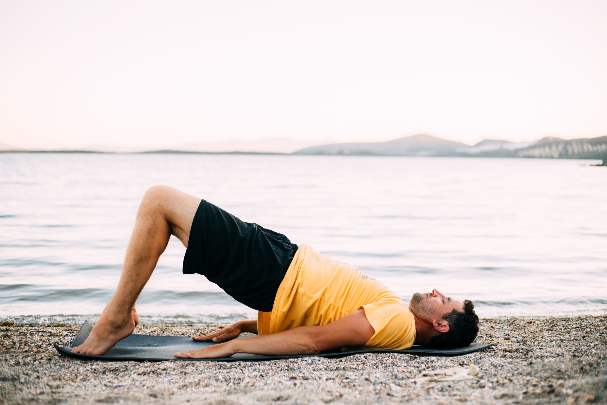 Man practising bridge pose (setu bandha sarvangasana)