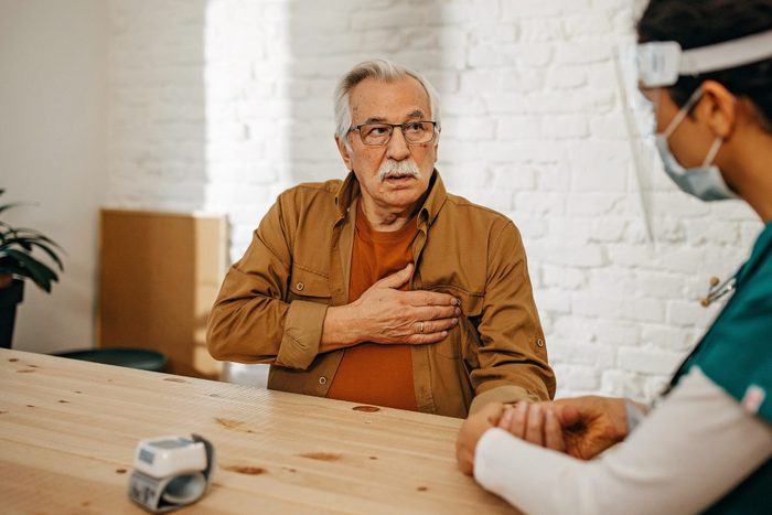 Doctor in home visit with senior man