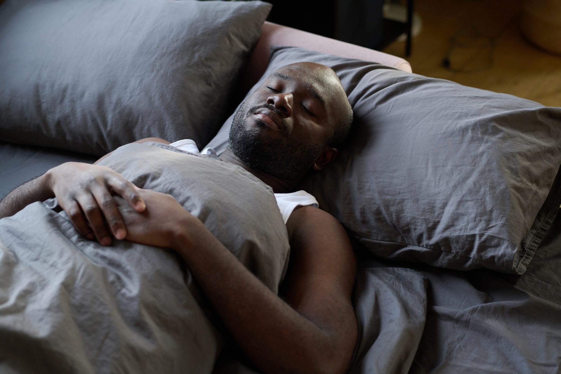 African man sleeping in his bed