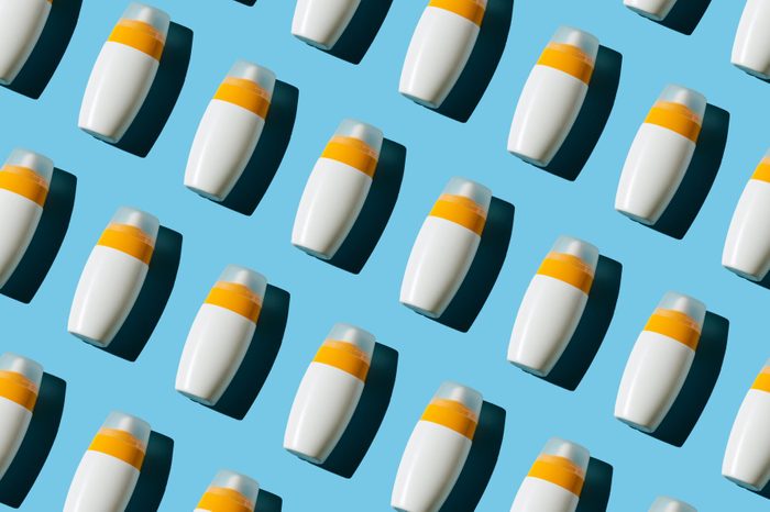 Pattern of sunscreen on blue background. Summer holidays concept.