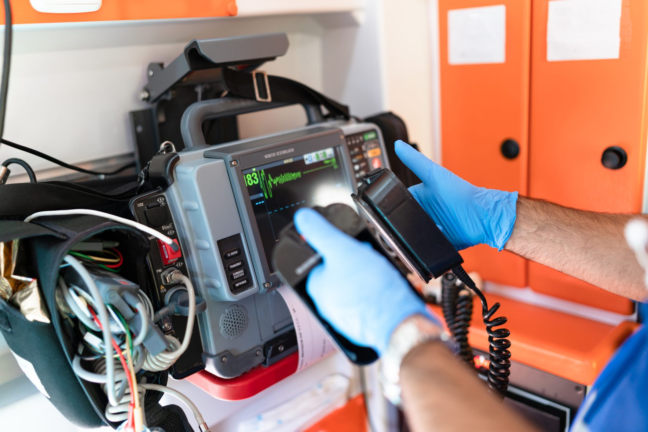 doctor using a defibrillator on an ambulance