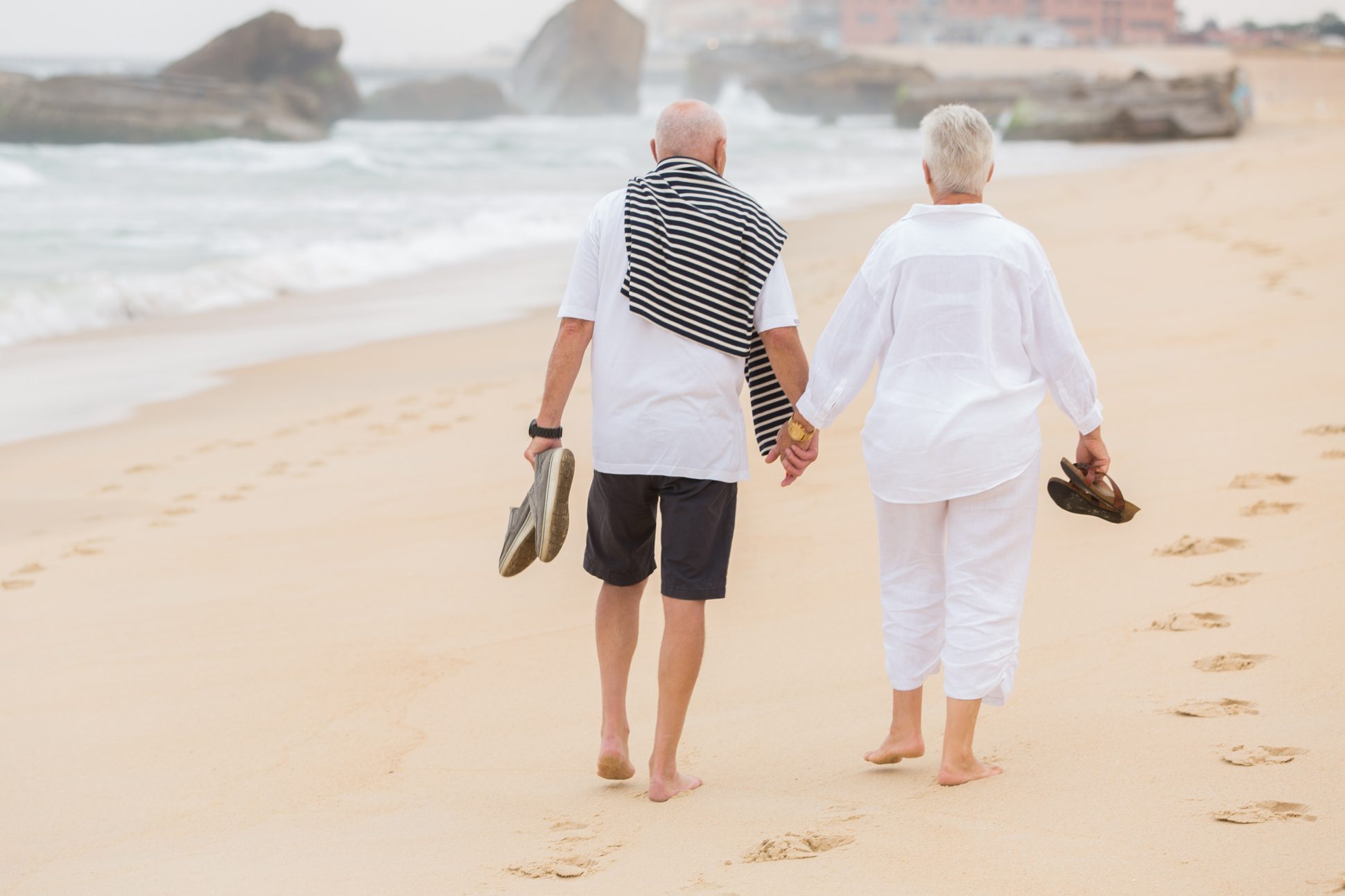 senior couple walking on the beach