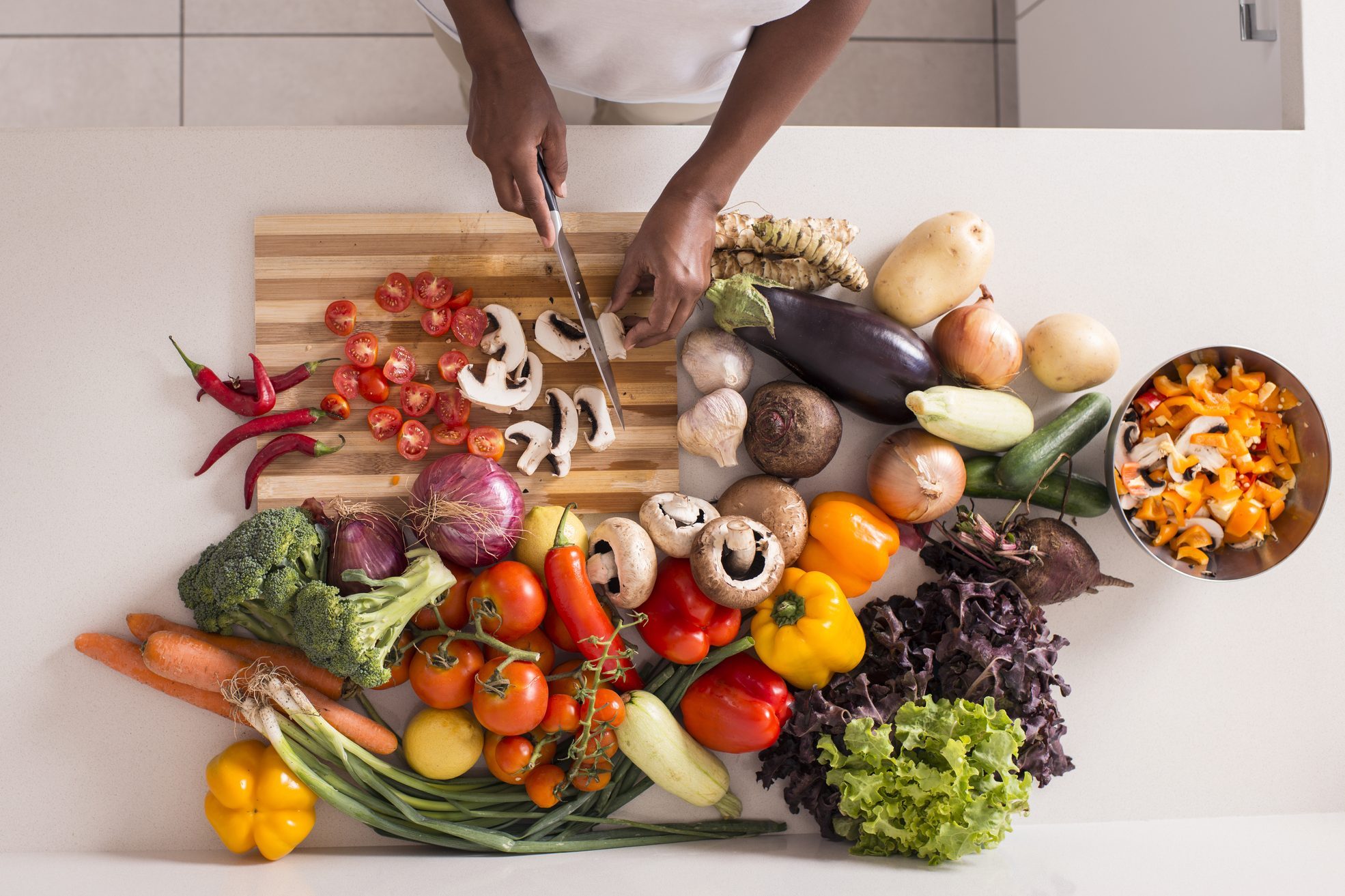 Unrecognized women preparing fresh healthy salad.