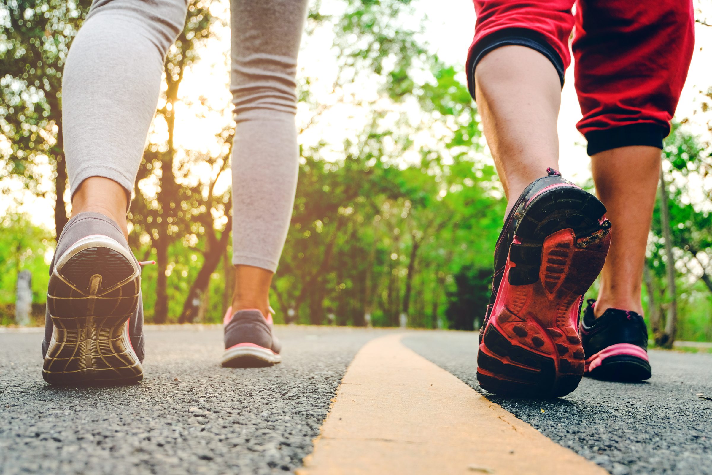 a couple walking on the road in sneakers