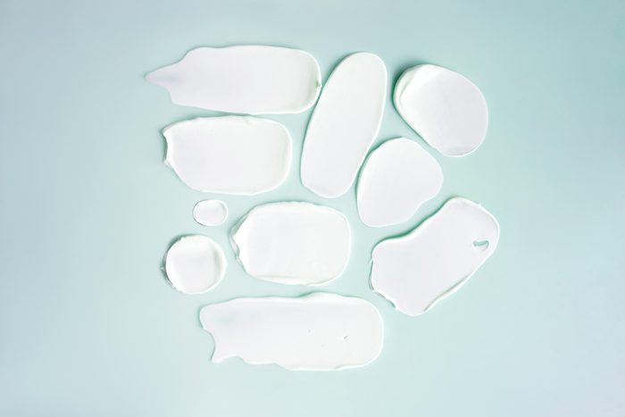 Sunscreen smears on a light blue background