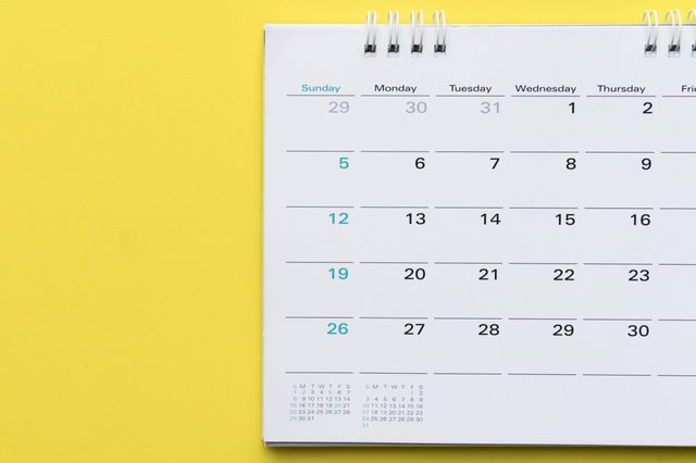 Close Up Of Calendar On Yellow Background Planning For Business Meeting Or Travel Planning Concept