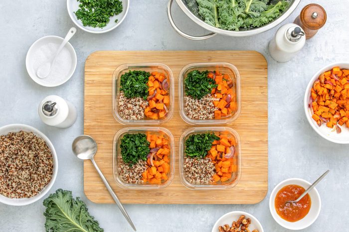 Preparing healthy vegetarian food ahead in lunch boxes, top down view