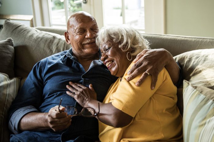 senior happy couple hugging on the couch