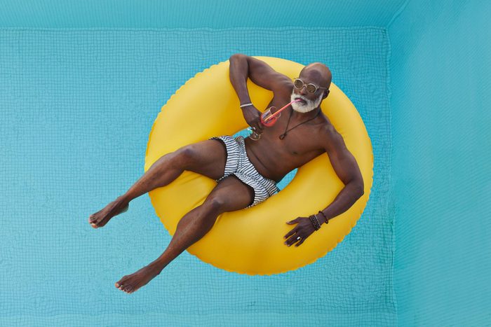 Bald man relaxing in yellow inflatable ring
