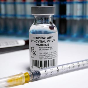 Respiratory Syncytial Virus Vaccine Vial and Needle resting on a counter in a medical setting