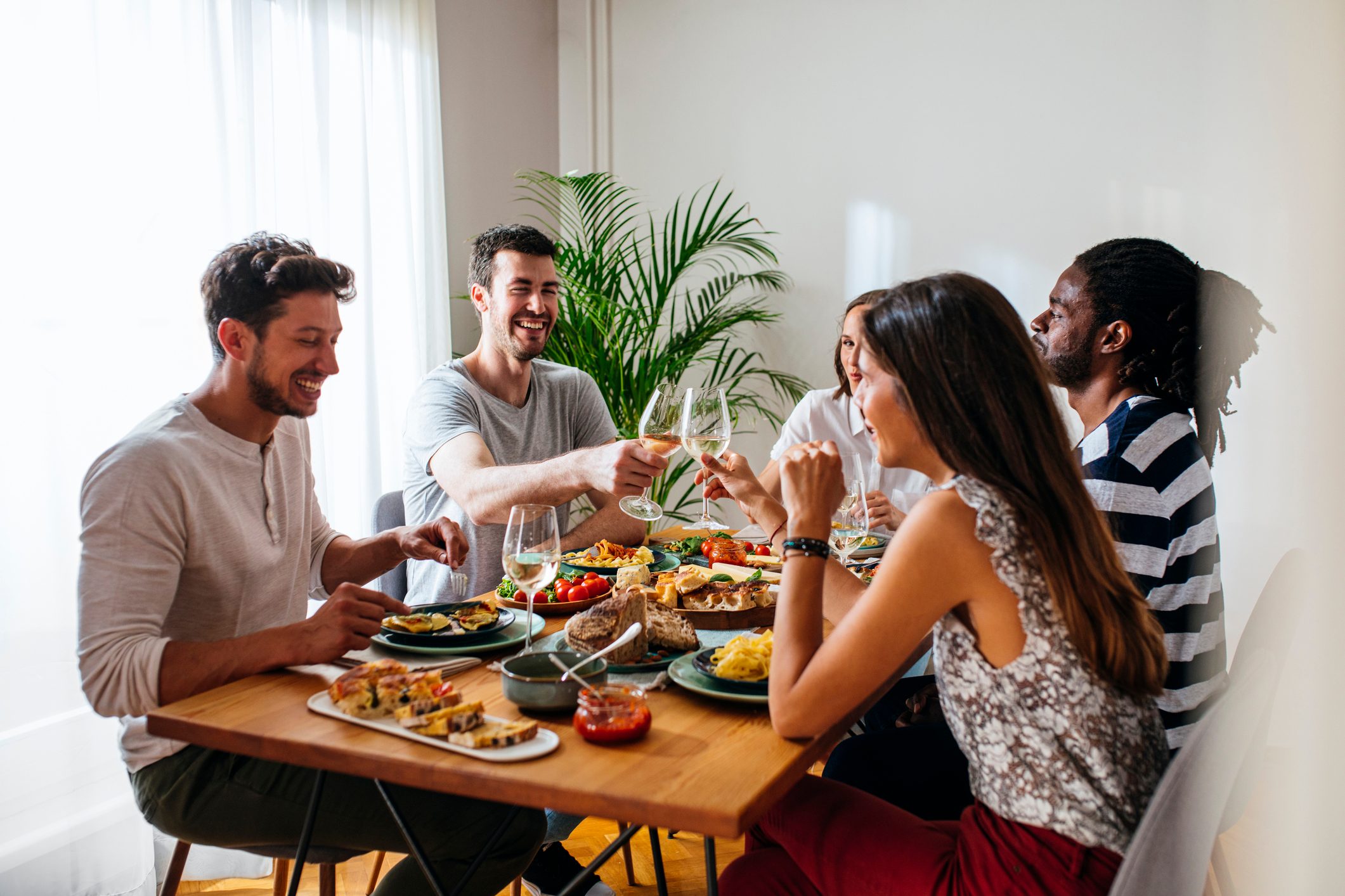 Friends Celebrating and Rising Wine Glasses