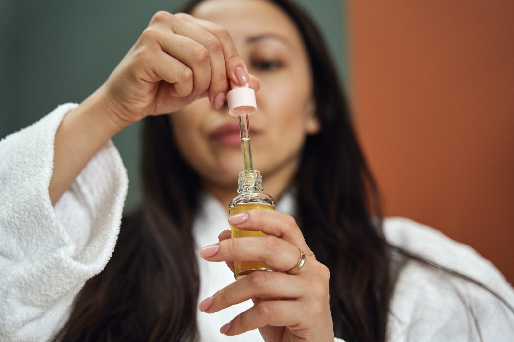 Closeup shot of hands with face serum